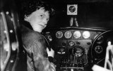 Amelia Earhart at the controls of an aircraft in France.