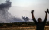 Kurdish man celebrates after an airstrike on ISIL at the southeastern village of Yumurtalik, in Sanliurfa province, near Kobane at the Syria-Turkey body. Getty
