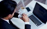 coffee laptop work man looking at watch