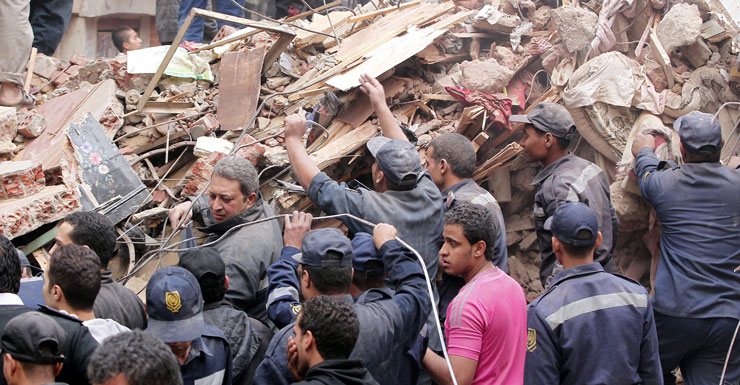 Rescue workers search the rubble after a building collapse in Cairo.