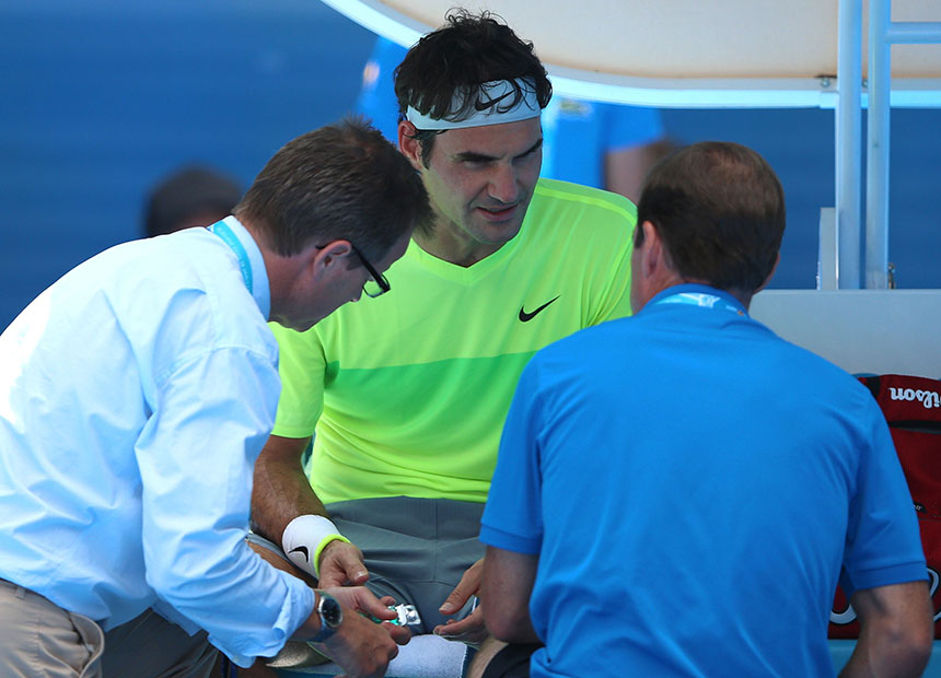 Roger Federer receives treatment for a bee sting.
