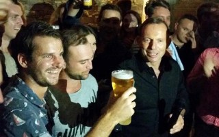 Tony Abbott celebrates after skolling a beer with the boys.