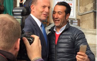 Tony Abbott poses with a visitor who wanted a selfie at the Blue Mosque in Istanbul, Turkey.