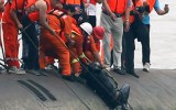 Divers extract a passenger from the river.