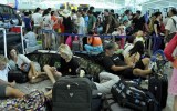 Passengers wait at Denpasar airport. flight delay bali virgin jetstar mt raung