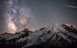 A meteor can be seen piercing through the darkness as the Milky Way towers above the 4,392m peak of Mount Rainier in Washington, USA.