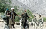 Afghan men are searched in Mullah Omar's heartland in 2004.