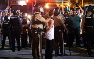Police detain a man during a civil disobedience action in Ferguson, Missouri.