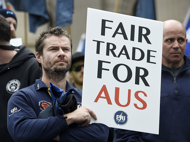 Union and community members rally to demand urgent changes to the China Australia Free Trade Agreement to protect jobs and safety standards on the front steps of Victorian Parliament in Melbourne on Friday, August 28, 2015. (AAP Image/Mal Fairclough) NO ARCHIVING, EDITORIAL USE ONLY
