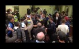 Police escorted the mayor out of the building.
