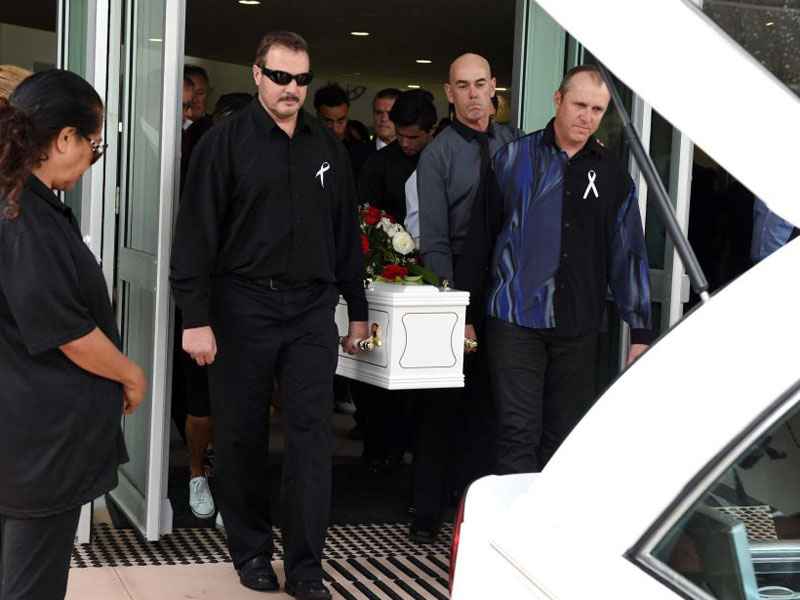 The coffin is carried out after the funeral service.