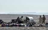 Egyptian soldiers stand guard next to debris and belongings of passengers of the plane.