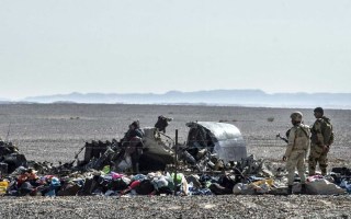 Egyptian soldiers stand guard next to debris and belongings of passengers of the plane.