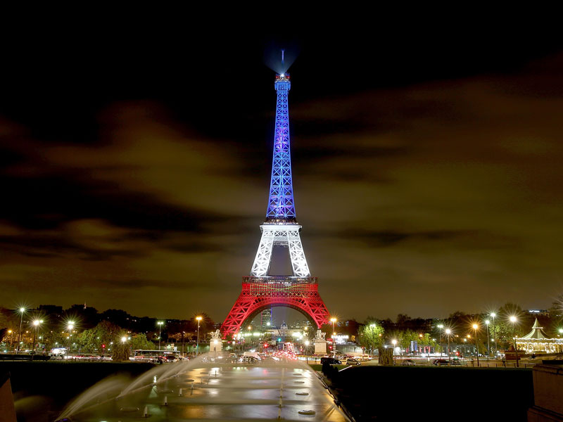 The Eiffel Tower was bathed in blue, white and red when it reopened.