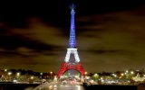 The Eiffel Tower was bathed in blue, white and red when it reopened.