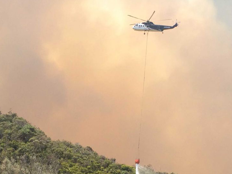 Helicopter drops water on flames Separation Creek