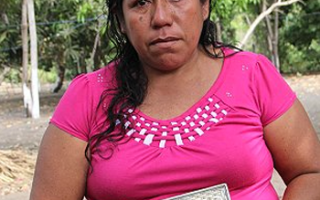 Roselia Diaz holds a picture of her dead son, Ezequiel.