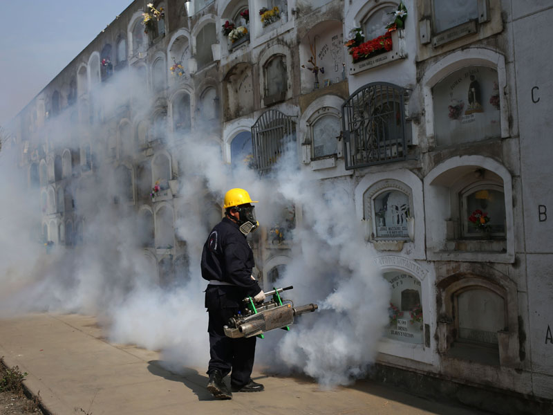 A health worker fumigates to prevent the virus spreading in Peru.