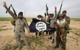Iraqi Shiite fighters with a captured Islamic State flag.