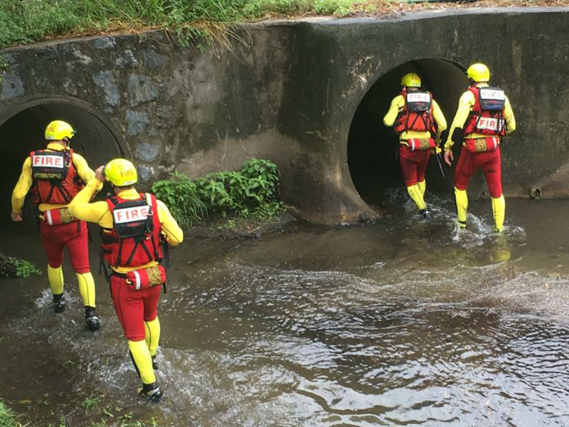 Fire crews enter a storm drain during the search.