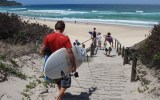 Surfers at Boomerang Beach, where a man died saving his son from a rip.