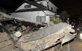 A collapsed house is seen after an earthquake in Kumamoto.