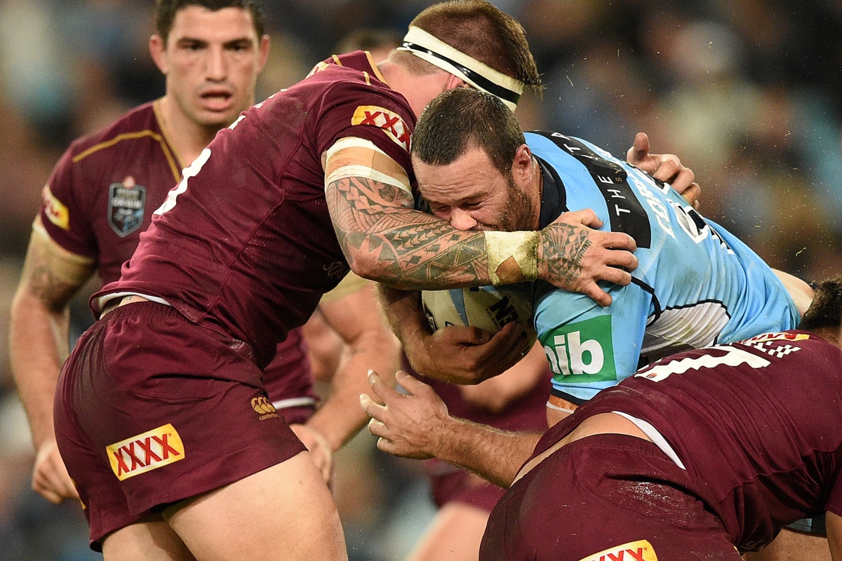Boyd Cordner of the Blues is tackled by Josh McGuire of the Maroons.