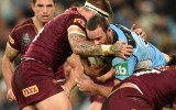 Boyd Cordner of the Blues is tackled by Josh McGuire of the Maroons.