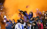 Fans ignite flares during the friendly between the Socceroos and Greece last night.