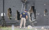 FBI agents investigate the damaged rear wall of the Pulse Nightclub. Photo: Getty.