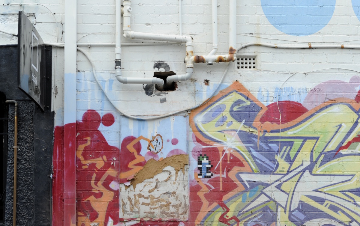 A Banksy artwork in Prahran has pipes put through it in 2012.