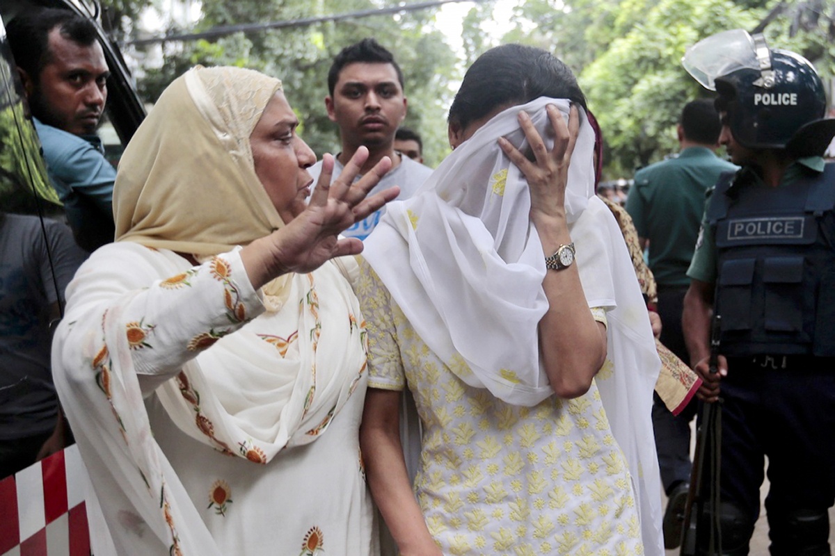 A relative tries to console a woman whose son is missing in Dhaka, Bangladesh.
