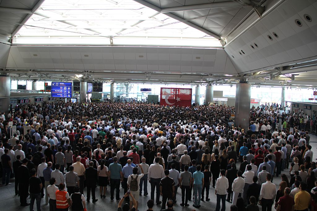 People attend a commemoratiom for victims of the Istanbul Airport attack.