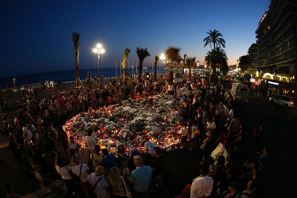 People gather at a makeshift memorial on the Promenade des Anglais in Nice.
