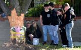Mourners lay flowers