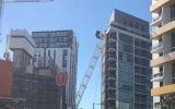 Crane collapses on apartment block
