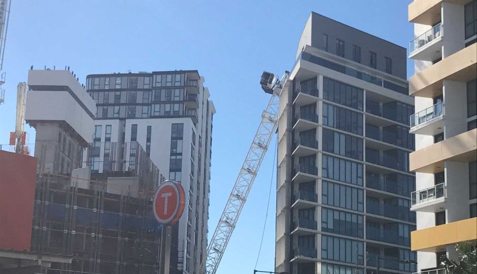 Crane collapses on apartment block