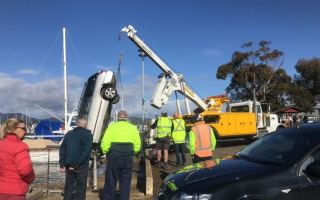 Jim McCrary's car is pulled out of the water at Triabunna