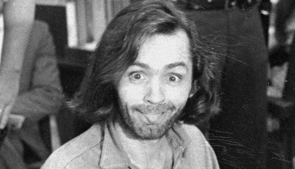 Charles Manson sticks his tongue out