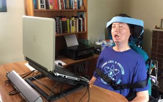 Michael Lee sitting at his desk in front of his computer