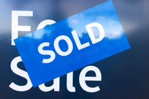 Sold sticker on a real estate sign