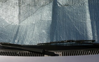 Car windshield being protected from the sun