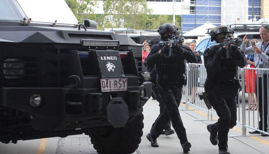 Tactical police at a media event on the Gold Coast take part in a training drill for the Commonwealth Games.