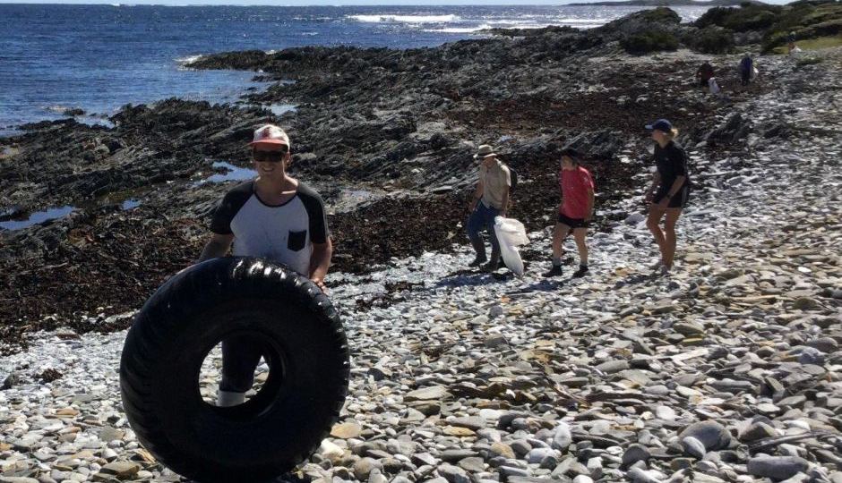 Volunteers collecting rubbish from a remote Tasmanian beach