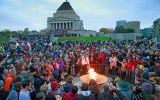 Crowds gathering around the eternal flame at the dawn service on Anzac Day at the Shrine of Remembrance.