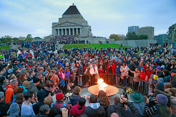 Crowds gathering around the eternal flame at the dawn service on Anzac Day at the Shrine of Remembrance.