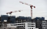 Two cranes building apartments in an Australian city.