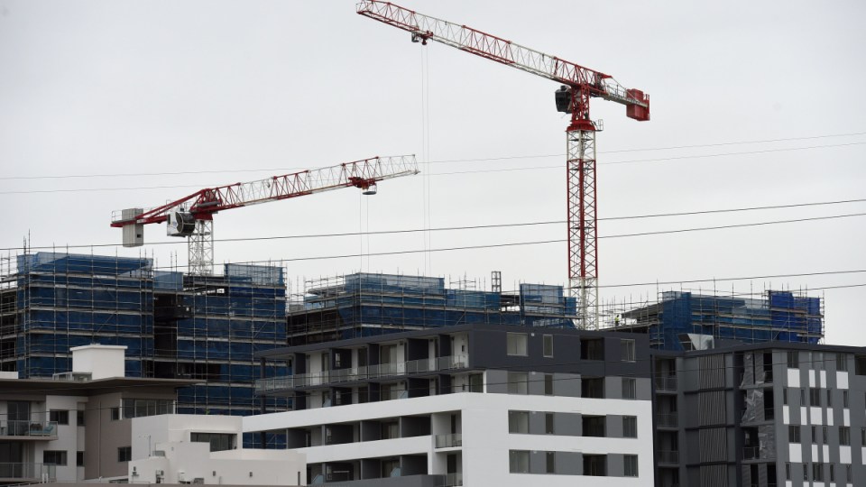 Two cranes building apartments in an Australian city.