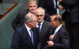 Tony Abbott, Malcolm Turnbull, and Scott Morrison on the floor of Parliament.