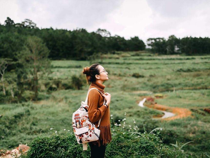 A young woman standing in a field.